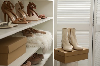 Photo of Shelving unit with stylish shoes in dressing room