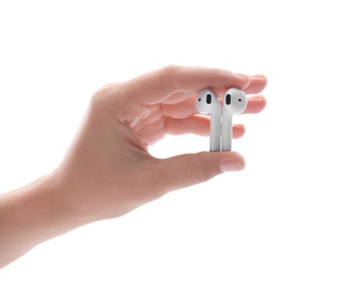 Photo of Woman holding modern wireless earphones on white background, closeup