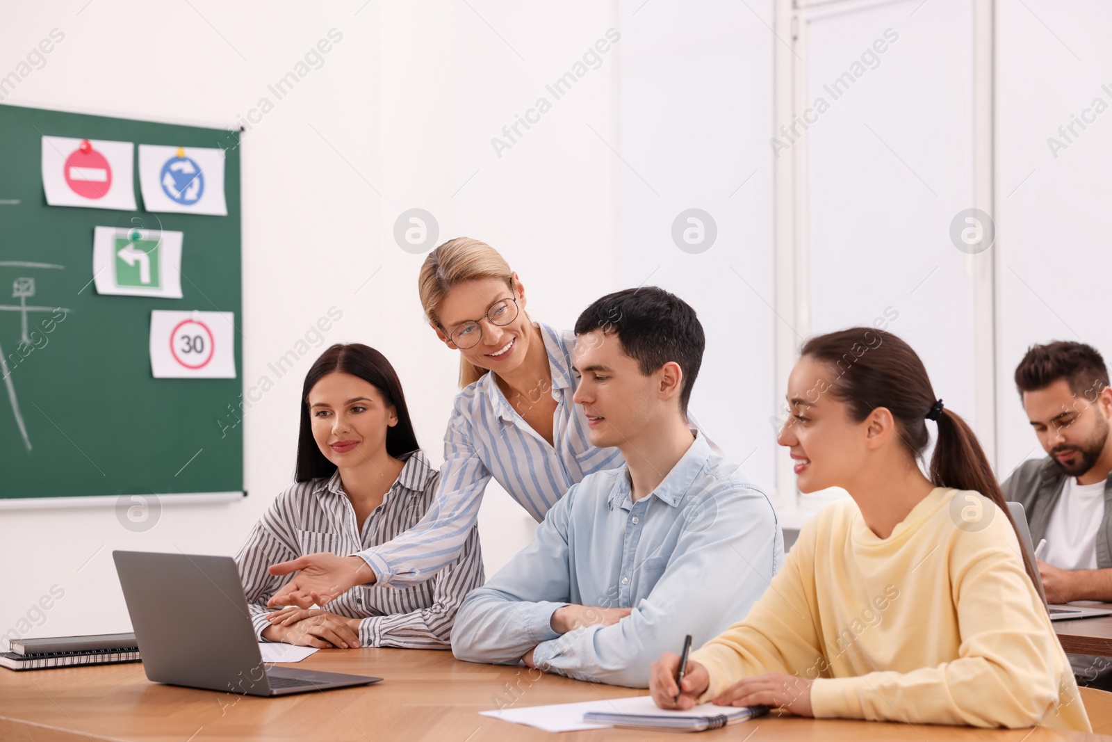 Photo of Teacher giving lesson to audience in driving school