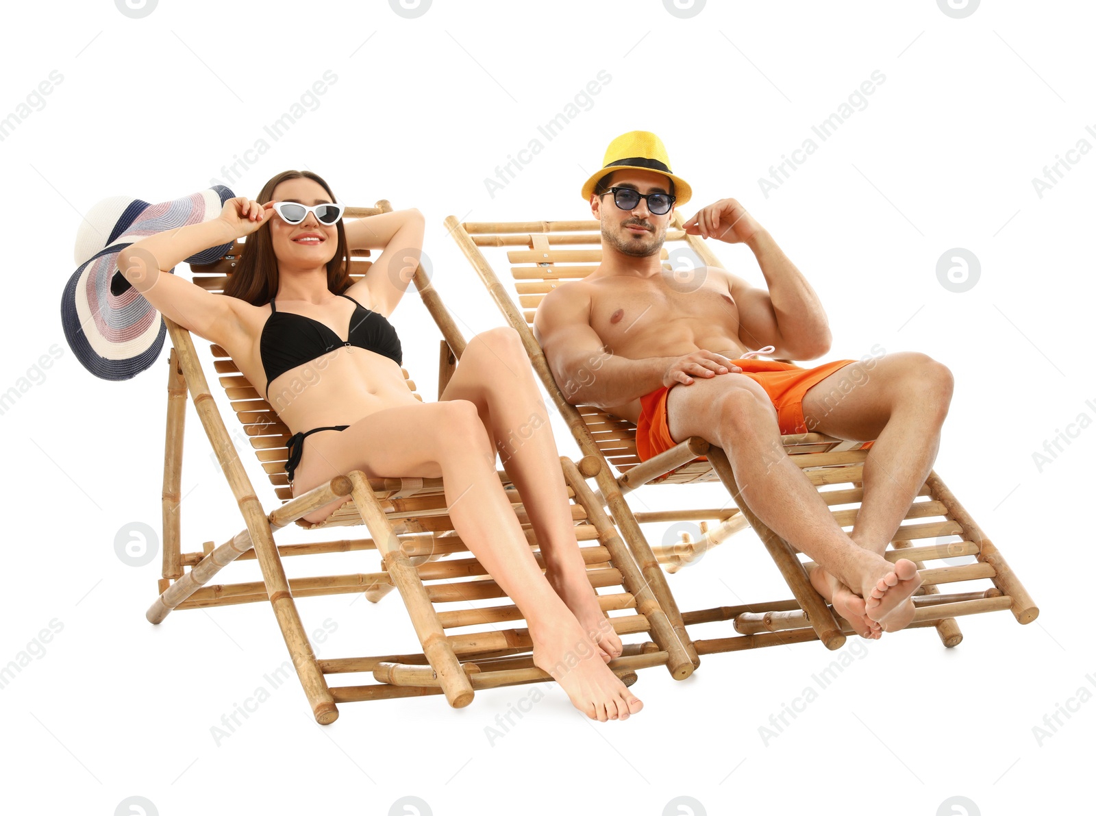 Photo of Young couple on sun loungers against white background. Beach accessories