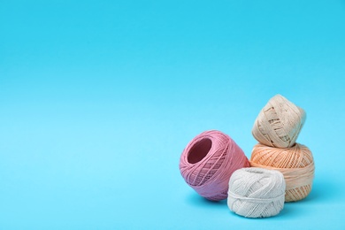 Photo of Different sewing threads on color background