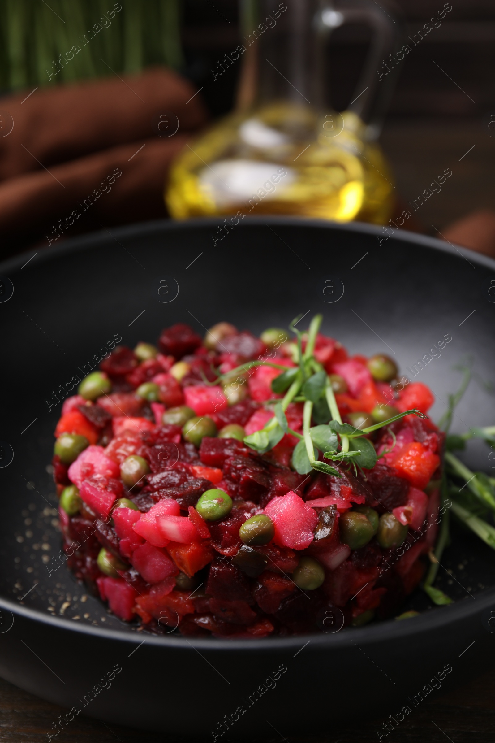 Photo of Delicious vinaigrette salad on table, closeup view