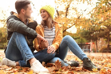 Lovely couple spending time together in park. Autumn walk