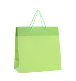 Photo of Green paper shopping bag isolated on white