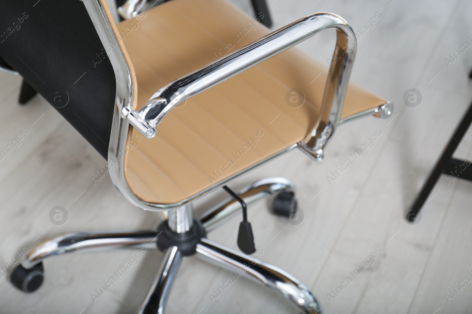 Photo of Modern comfortable office chair in room, closeup