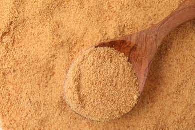 Photo of Brown coconut sugar and spoon, top view