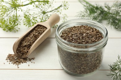 Dry seeds and fresh dill on white wooden table, selective focus. Space for text