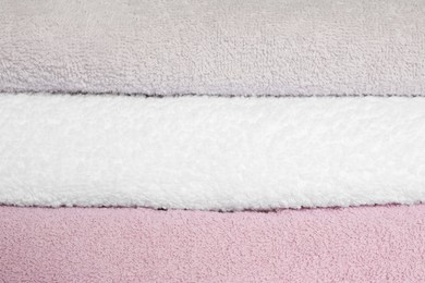 Photo of Stack of clean soft towels as background, closeup