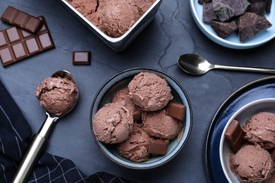 Photo of Yummy chocolate ice cream served on black table, flat lay