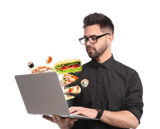 Image of Young man using laptop for ordering food online on white background. Delivery service during quarantine
