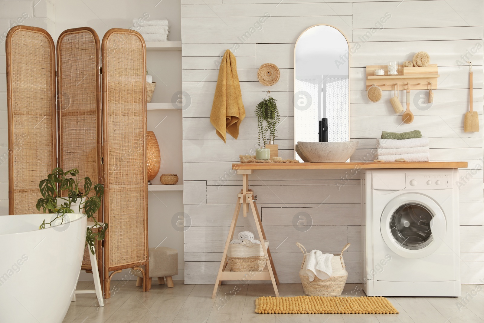 Photo of Stylish bathroom interior with modern washing machine