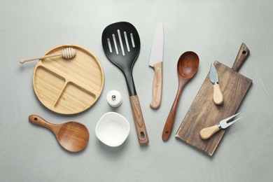 Photo of Set of different kitchen utensils on grey table, flat lay