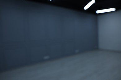 Blurred view of empty renovated room with light walls