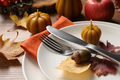 Photo of Festive table setting with autumn decor on wooden desk, closeup
