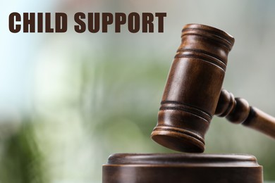 Image of Judge's gavel on blurred background, closeup. Child support concept