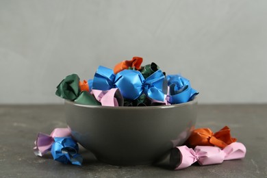 Candies in colorful wrappers on grey table