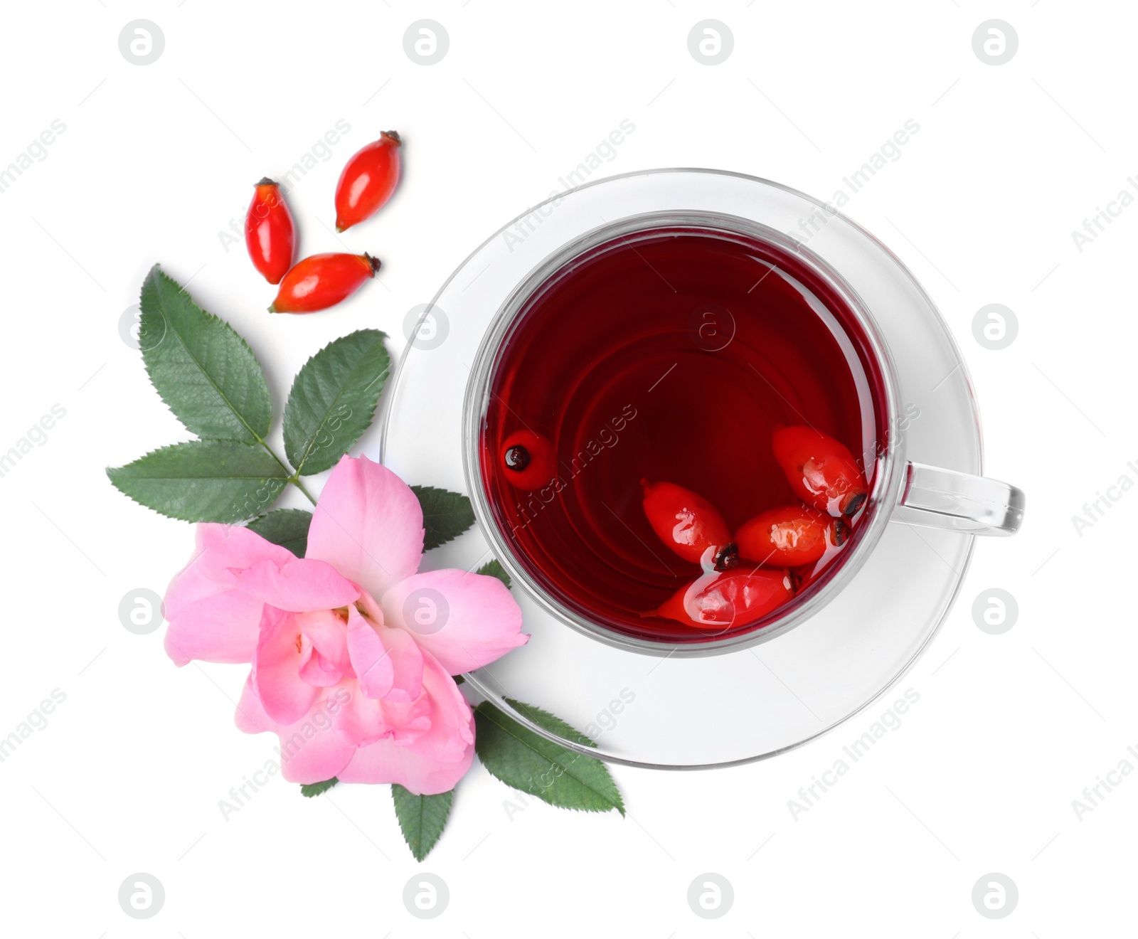 Photo of Aromatic rose hip tea, flower and fresh berries on white background, top view