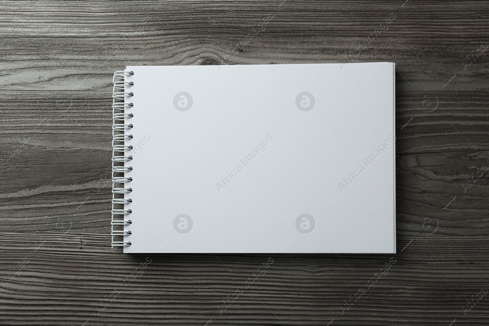 Photo of Blank paper brochure on wooden table, top view. Mockup for design