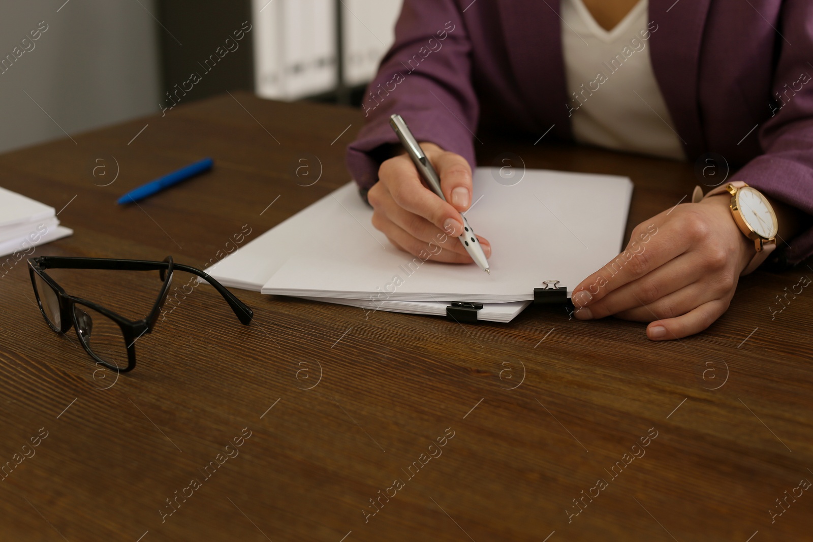 Photo of Businesswoman working with documents at office table, closeup