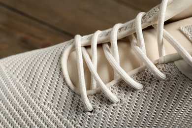Photo of Stylish shoe with beige laces, closeup view