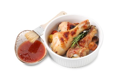 Photo of Marinade, basting brush, roasted chicken drumsticks, rosemary and tomatoes isolated on white