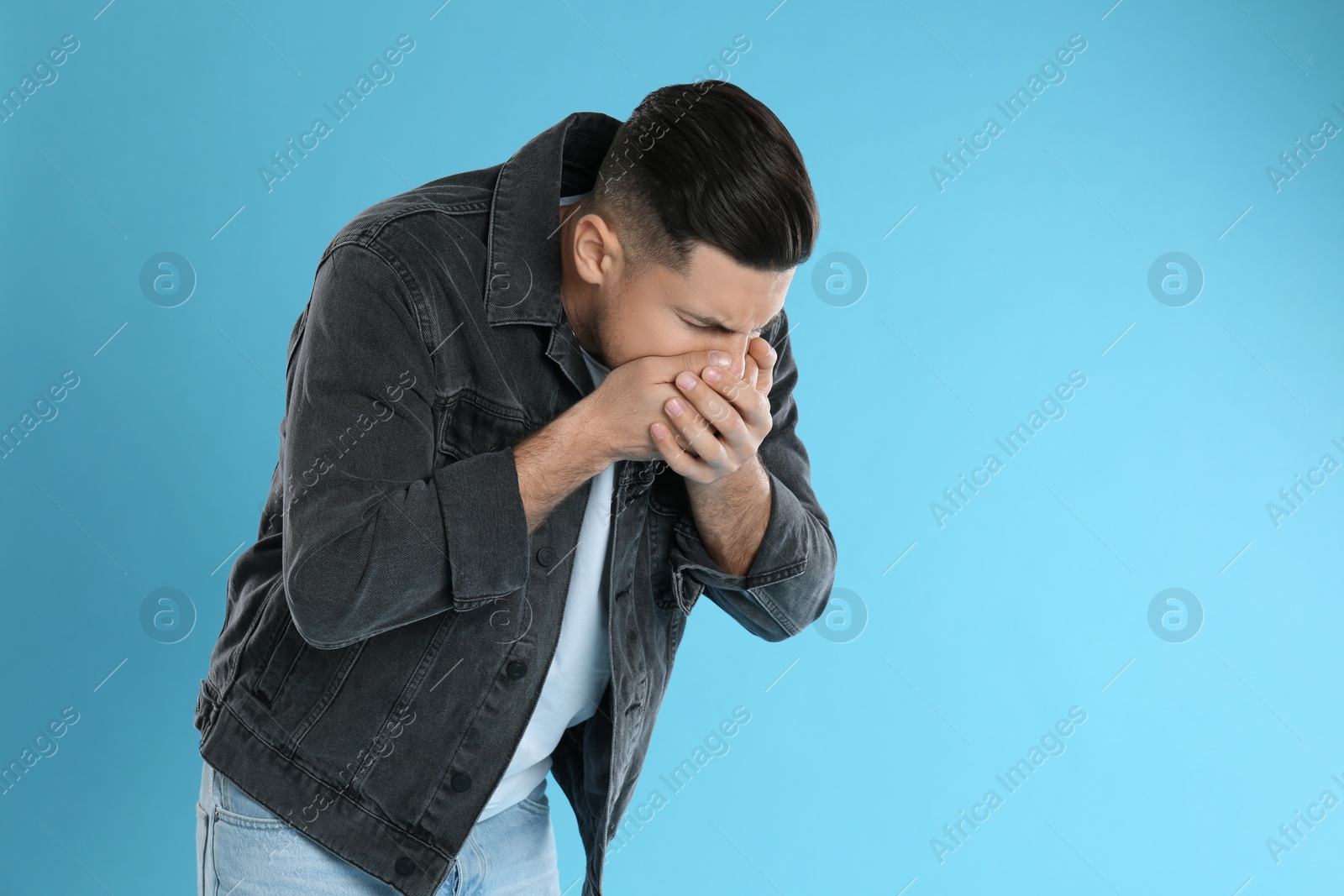 Photo of Man suffering from nausea on light blue background, space for text. Food poisoning