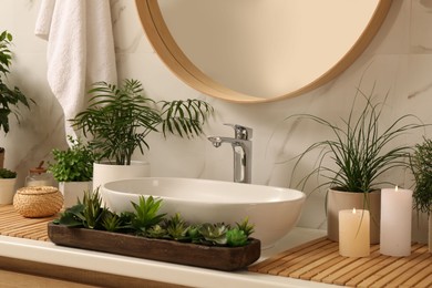 Photo of Counter with sink and many different houseplants near white marble wall
