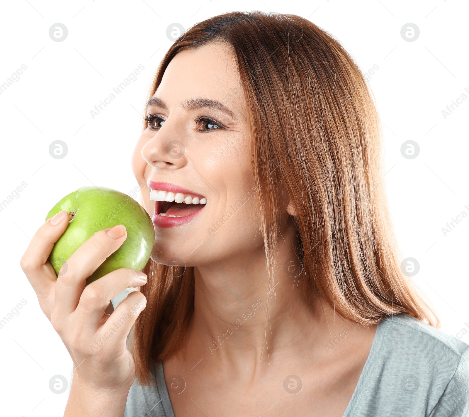 Photo of Smiling woman with perfect teeth and green apple on white background