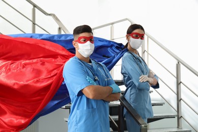Photo of Doctors dressed as superhero in hospital. Concept of medical workers fighting with COVID-19
