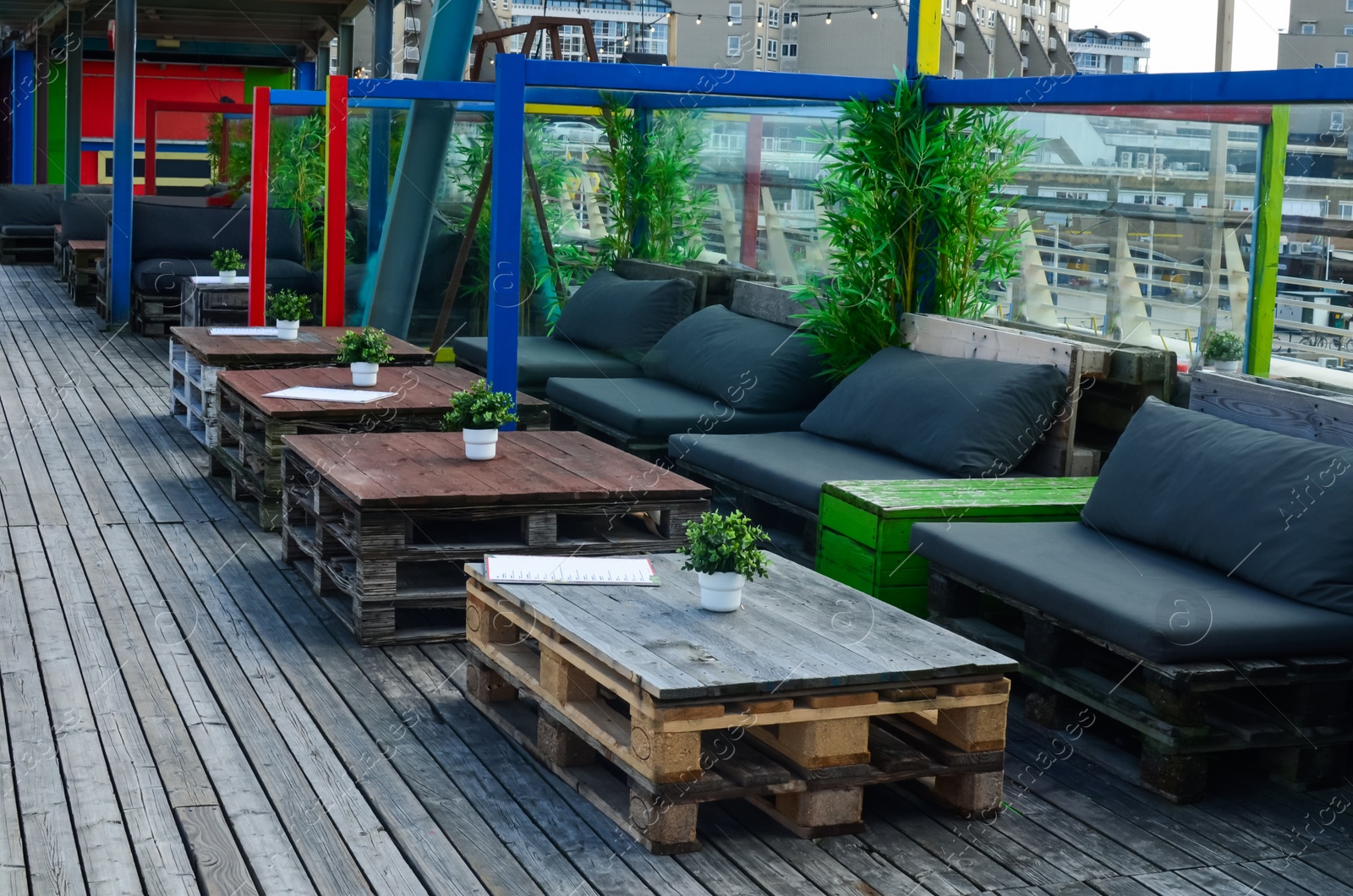 Photo of Beautiful straw beach umbrellas in modern outdoors cafe