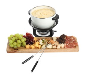 Fondue with tasty melted cheese, forks and different snacks isolated on white