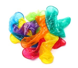 Pile of unrolled bright condoms on white background, top view. Safe sex