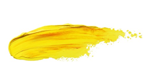 Photo of Yellow oil paint stroke on white background, top view