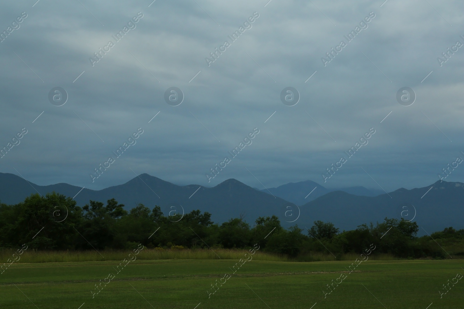 Photo of Picturesque view of foggy mountain landscape and beautiful sunset sky