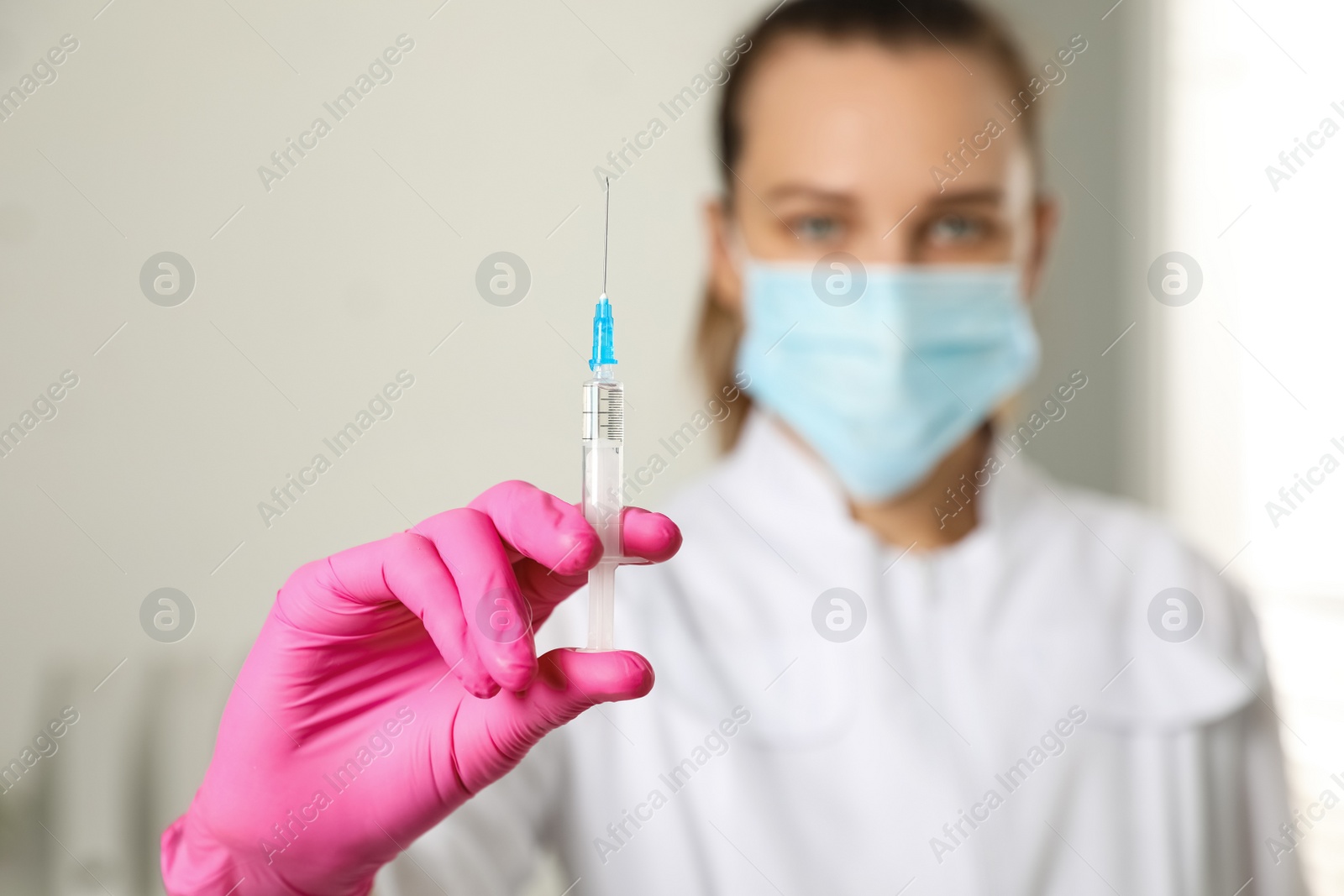 Photo of Doctor with syringe in hospital, focus on hand. Vaccination day