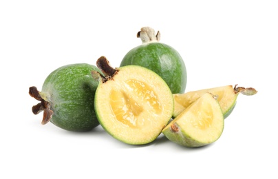 Photo of Cut and whole feijoas on white background