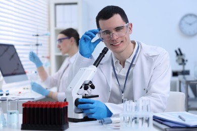 Scientist working with microscope in laboratory. Medical research