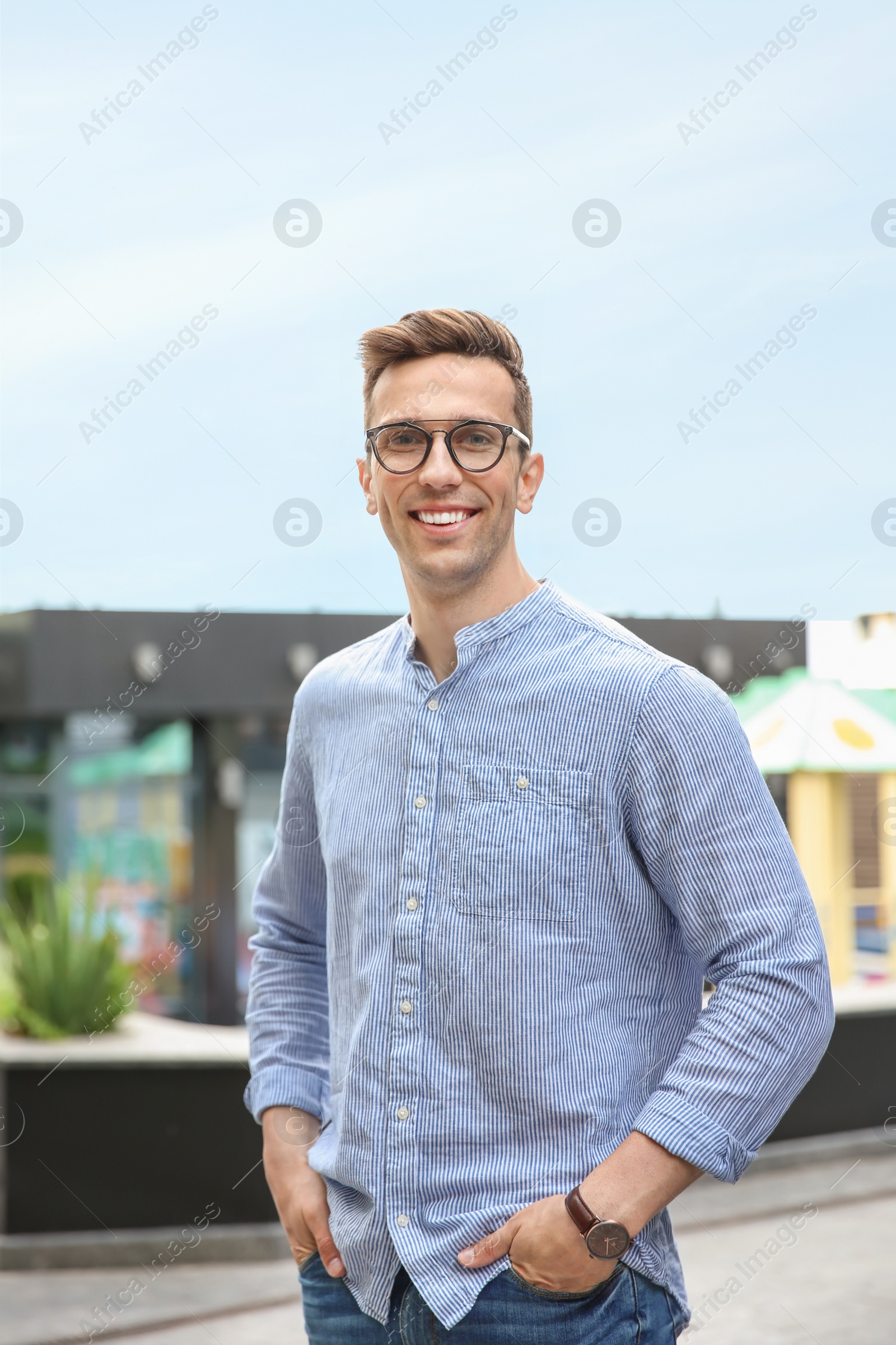 Photo of Portrait of attractive young man in stylish outfit outdoors