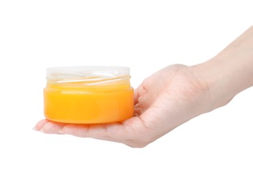 Woman holding jar of petrolatum on white background, closeup