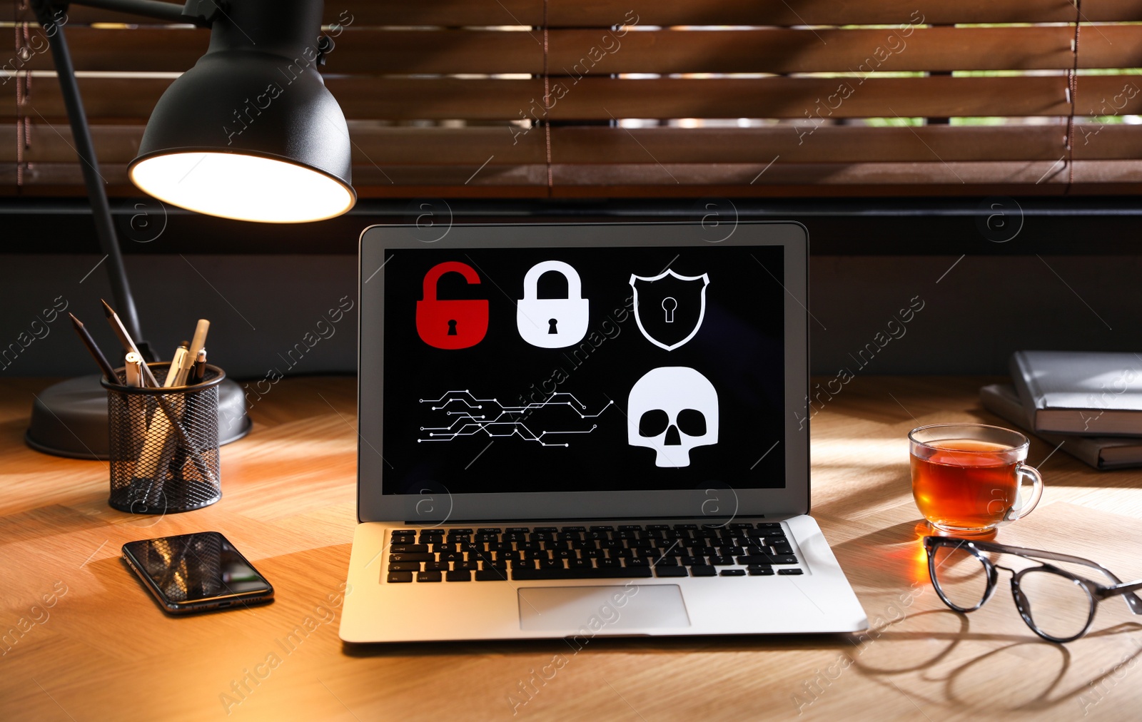 Photo of Laptop with virus illustration on wooden table in office