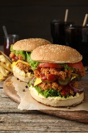 Photo of Delicious burgers with crispy chicken patty on wooden table