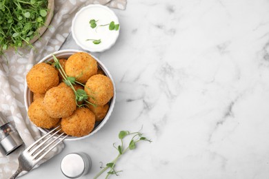 Photo of Bowl of delicious fried tofu balls with pea sprouts on white marble table, flat lay. Space for text