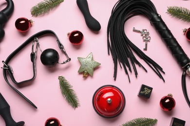 Set of different sex toys and Christmas decorations on pink background, flat lay