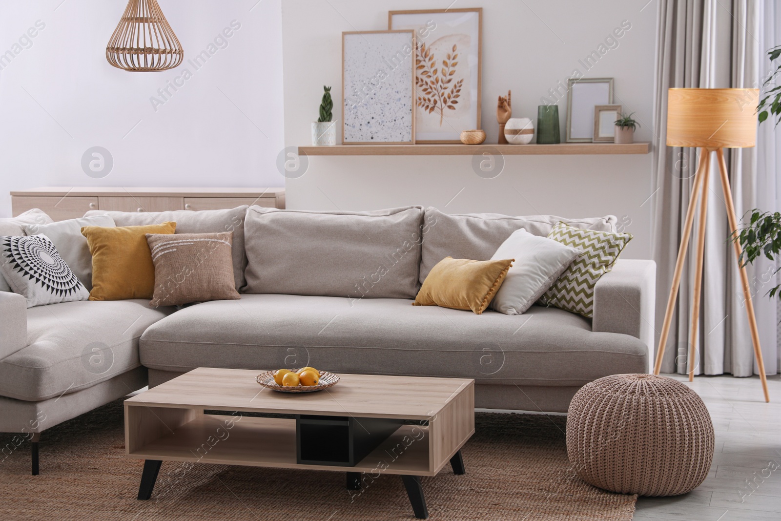 Photo of Stylish living room interior with comfortable grey sofa and coffee table