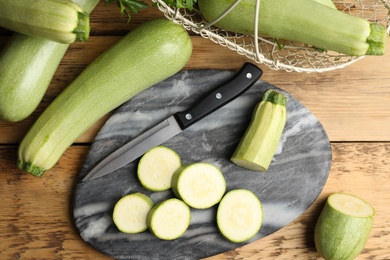 Photo of Green ripe zucchinis on wooden table, flat lay