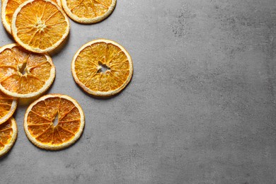 Dry orange slices on light grey table, flat lay. Space for text