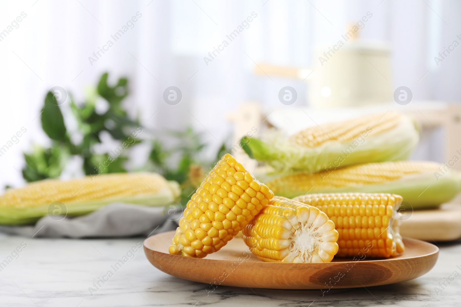 Photo of Plate with tasty sweet corn cob on table