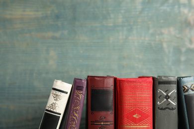 Photo of Collection of old books on blue wooden background. Space for text