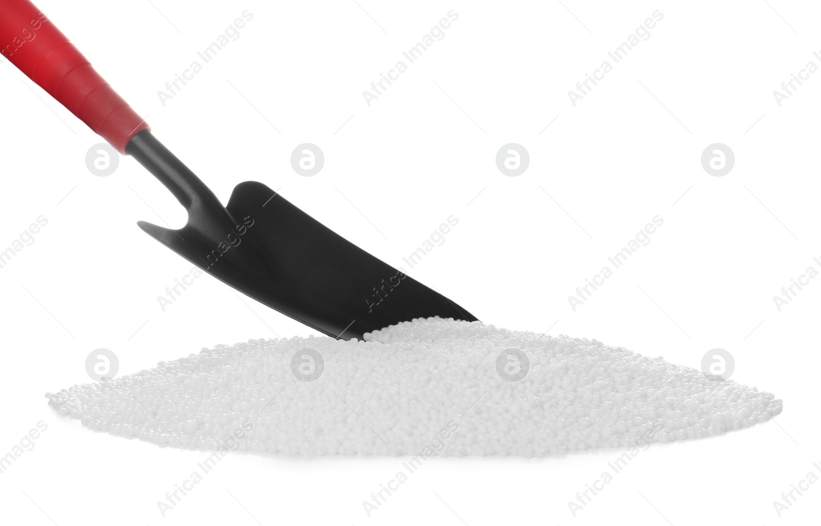 Photo of Pile of granular mineral fertilizer and scoop on white background