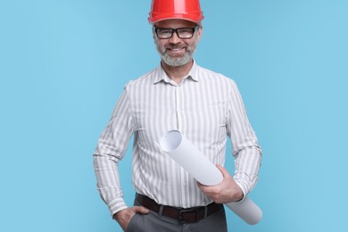 Photo of Architect in hard hat holding draft on light blue background